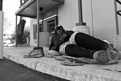 A homeless man sits in downtown Tucson. (Photo by Nels Bergeron)