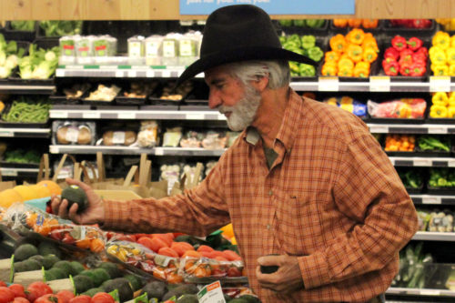 Buck Reed picks out avocados at Whole Foods in Tucson. A new study expects staple crops to lose some nutritional value as CO2 emissions continue to rise. Photo by: J.D. Molinary for Arizona Sonora News.