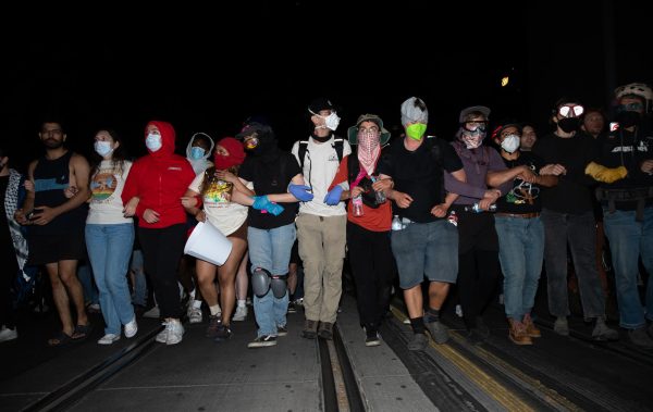 Protestors move down Park Avenue as arrests are made and police use chemical munitions on protestors early May 1. Protestors would disperse once police arrived in front of the Manzanita Mohave dorm.
