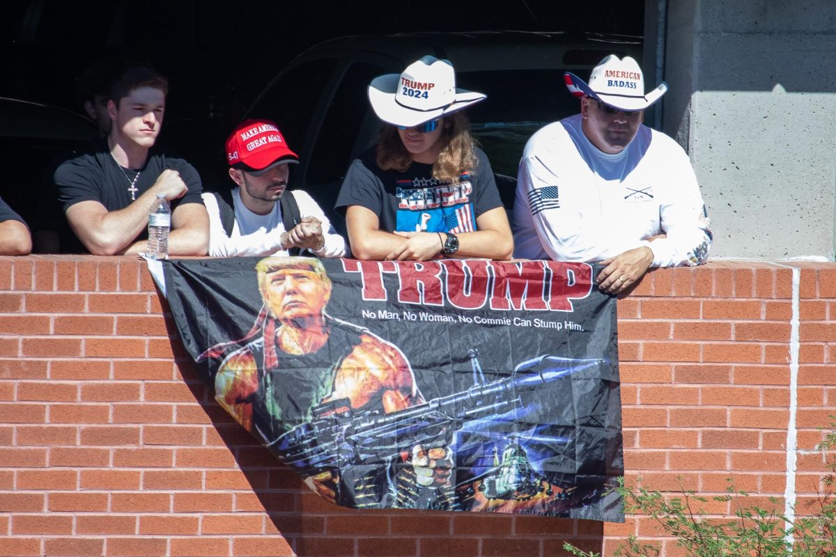 Students and community members gathered at the back of the Students Union at the University of Arizona to here republican influencer Charlie Kirk talk on Oct. 16. Kirk handed out 'Make America Great Again' hats while students hung Trump flags and chanted the MAGA slogan. 