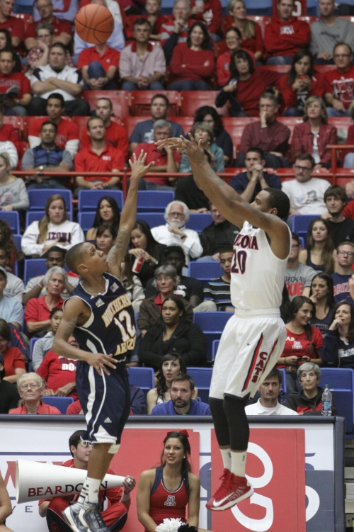 NAU's Dewayne Russell defends Arizona's Jordin Mayes in a matchup with Arizona last year. Russell was the Lumberjacks second-leading scorer. Photo by Larry Hogan/Arizona Daily Wildcat
