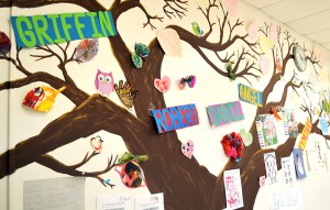 A painted tree decorated with student artwork stretches across a wall in Cyndee Wing's classroom. Wing said that she tries to incorporate at least one art activity into each day's lesson plan. (Photograph by Austin McEvoy) 