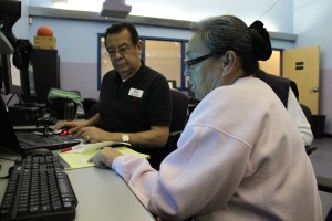Alex Cooper assists Susana Guerrero through the healthcare enrollment process at the Tucson Urban League on March 1.