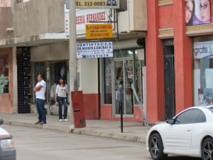 A storeowner stands outside his shop, surveying an empty Calle Alvaro Obregón on Sept. 16. Photo by Steven McManus.