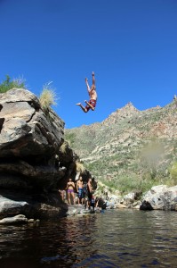 Gary Knecht, a 44-year-old Tucson resident, jumps off a cliff in Sabino Canyon. Photograph by Mark Armao. 