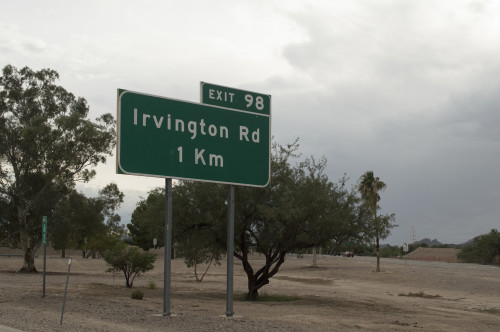 Highway sign displaying distance in kilometers near I-19 and Ajo in Tucson, Ariz. Photo by Brian Valencia