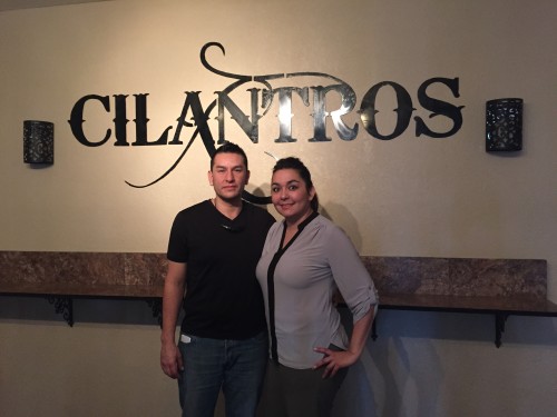 Jerry and Lizeth Piña pose inside of their bar, Cilantros. Photo by Larissa Teran