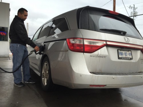 Isidro Alvarado, a fiscal consultant, pumps gasoline at Ed’s Shell Gas Station at 232 W Crawford St. in Nogales, Ariz. rather than pumping at a Pemex gas station. (Photo by Crystal Bedoya) 
