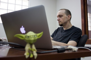 Justin Fleecer, co-founder of Desert Owl Games, works with some computer code for a video game in their new office in Tucson, Ariz. on Monday, May 4, 2015. Photo by Rebecca Marie Sasnett / Arizona Sonora News Service