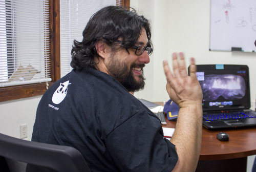 Arthur Griffith (left), CEO of Desert Owl Games, talks with a University of Arizona business partner about a new video game created for mining safety, called "Harry's Hard Choices," in their new office in Tucson, Ariz. on Monday, May 5, 2015. Photo by Rebecca Marie Sasnett / Arizona Sonora News Service