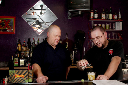 Patrick Night is shown by Mike Nowacki how to eyeball the level of alcohol when pouring drinks in the Bartending Academy in Tempe, Ariz. Night, who was a truck driver for the past 30 years, wants to get out of his cab and meet people. (Photo by Alamri/Arizona Sonora News)