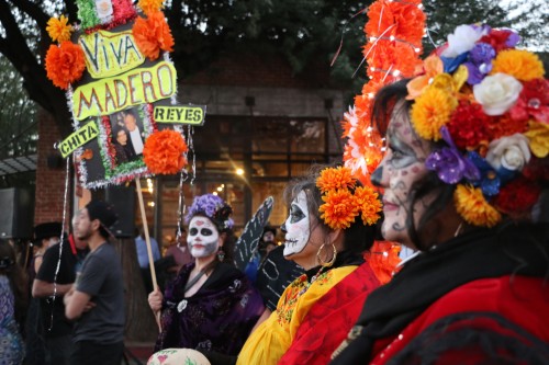 Families gather with homemade tributes to deceased loved ones at the All Souls Procession. Photo by Jennifer Hijazi