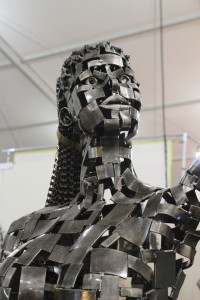 A metal sculpture of a woman titled 'Serenity,' was created by artist John T. Benedict of Some Distant World, shown at the JG&M Expo of the Tucson Gem, Mineral and Fossil Showcase in Tucson, Ariz. on Jan. 31, 2016. Her hair is created from bike chains, and according to Benedict, is fully flexible. (Photo by Maggie Driver.)