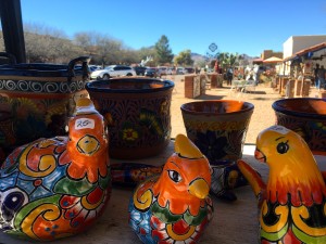 Mexican ceramic painted birds. In the background are the busy streets of the Tubac village. (Photo by: Sara Cline)