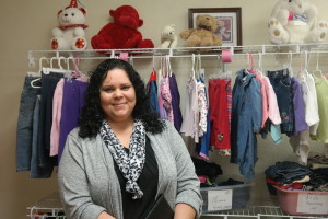 Tina Upshaw, executive director of CareNet Pregnancy Center of Cochise County stands in front of her clinic's baby boutique. Parents may exchange "mommy money and daddy dollars" earned through taking classes for clothes, toys, books and more. (Photo by: David Mariotte/ Tombstone Epitaph)