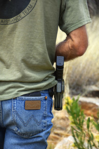 Foley straps a gun to his hip while making his rounds near the border fence. (Photo by Kendal Blust/Arizona Sonora News)