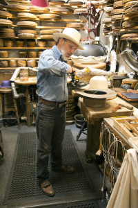 S. Grant Sergot expone un sombrero al vapor para un encargo de un cliente, alistándose para moldear el borde. Sergot mencionó que es un proceso un poco lento ya que toca “convencer” al sombrero para que tome la forma deseada. Fotografía por Karen Schaffner/un servicio de Arizona Sonora News.