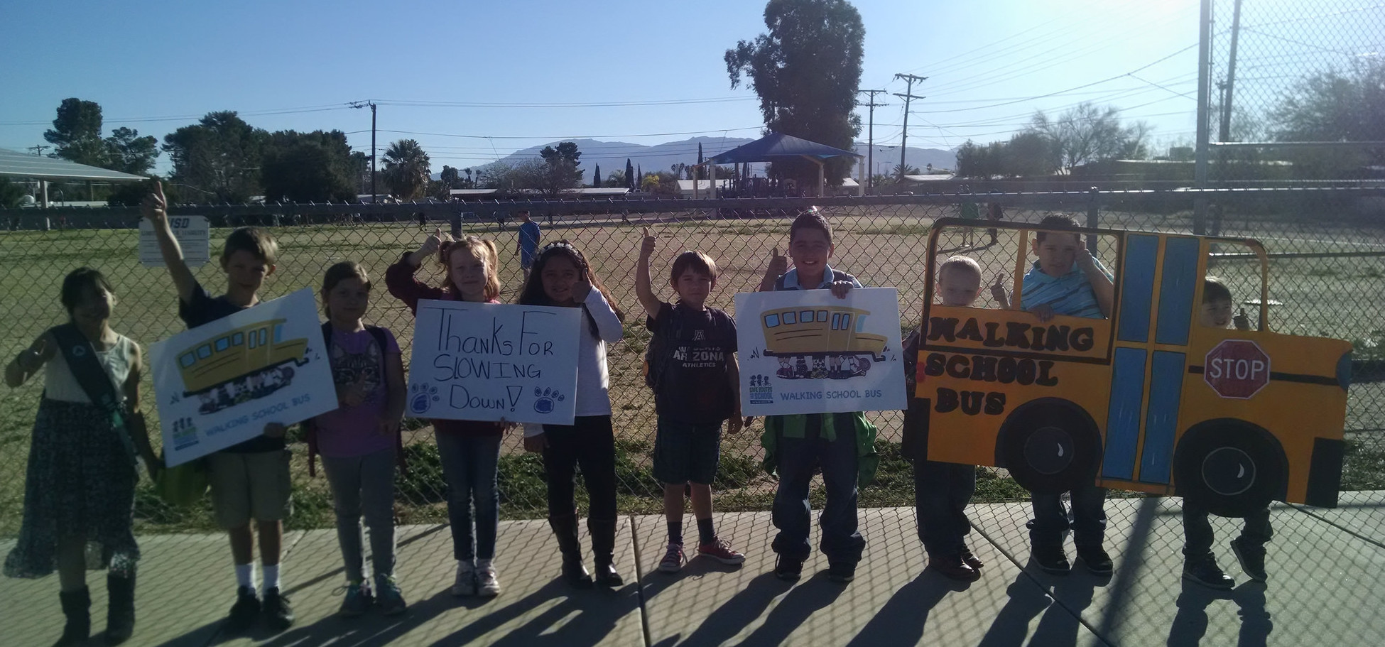 Kids part of the WSB program pose with their signs. Photo by Safe Routes Tucson.