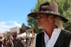 Gene Alberts stands on Allen Street directing passersby to the Good Enough Mine tours in Tombstone, Ariz. on Sunday, Sept. 25, 2016. (Photo by Julianne Stanford / Arizona Sonora News Service)