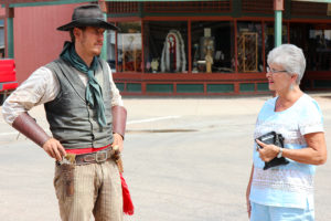 Kay Honn asks gunslinger Jake Stollings for directions around the town in Tombstone, Ariz. on Sunday, Sept. 27, 2016. (Photo by Julianne Stanford / Arizona Sonora News Service)
