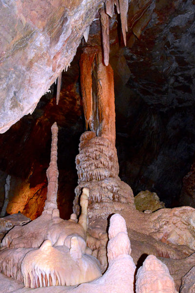 This stalagmite in the "strawberry room" resulted from a fast and abundant drip source. Visible contrast in color with the formations in the foreground indicates a mostly pure calcite composition, generating lighter colored formations. (Photo courtesy of Kartchner Caverns State Park)