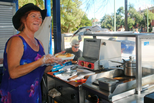 PJ Csoka serves hot dogs outside of the Harvill Building on the University of Arizona campus in Tucson on Oct. 14, 2016. PJ hasn't missed a single day of work since she started almost 4 years ago. (Photo by Jacquelyn Silverman / Arizona Sonora News)