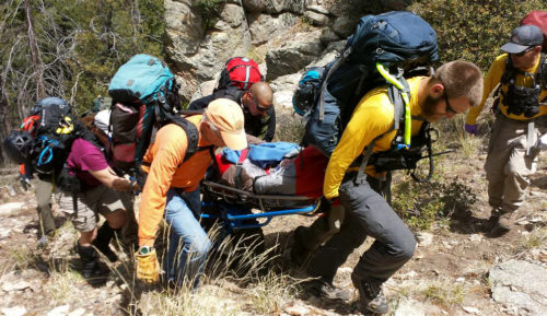 Southern Arizona Rescue Association members practice the skills needed to safely evacuate an injured subject in a wheeled stretcher across mountainous terrain in May of 2015. Volunteers respond 24 hours a day, seven days a week and 365 days a year to aid ill, injured, or lost individuals on Southern Arizona hiking trails or backcountry. (Photo courtesy of Southern Arizona Rescue Association)