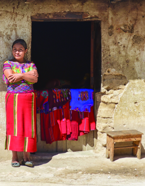 A woman sells her weaving on the street in Nahuala, Guatemala on August 2, 2016. Selling weavings in one of the few ways that indigenous woman can make a living.