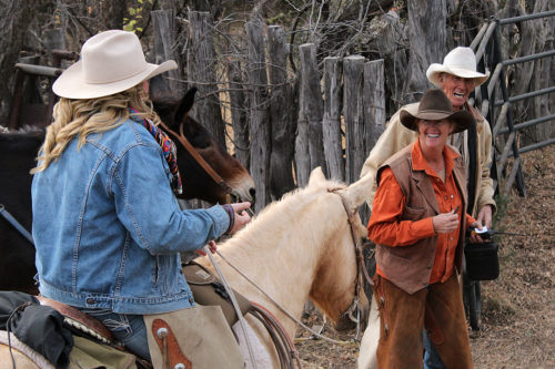 Kelly Glenn Kimbro laughs with her daughter, Mackenzie Kimbro, on horseback, and her father, Warner Glenn, during the cattle round up on Saturday, Nov. 25, 2016. Kelly and her family work together when ranching, their family has been on the same land they are on since 1896. (Photo by Michelle Floyd / Arizona Sonora News)