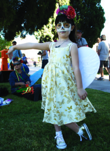 Ripley Mayaraso, 4, poses for a photo at the Little Angels Procession, showing off her angel wings. Photo by: Christina Duran