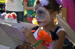 Mia Ramirez, 6, thinks of whom to write a poem for at the Little Angels Procession. Photo by: Christina Duran