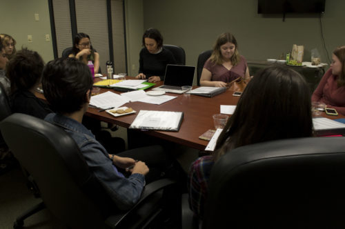 Mari Galup, Unidas program coordinator, leads a discussion about local organizations, the girls researched.