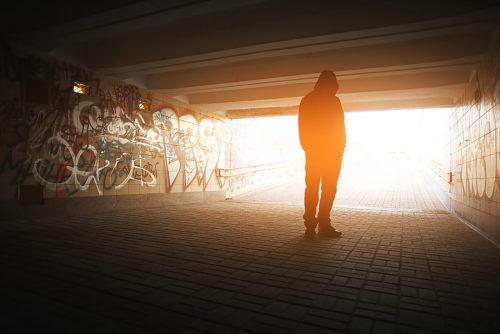 A homeless youth stands in a street tunnel in Tucson, Ariz. (Photo by: Our Family Services