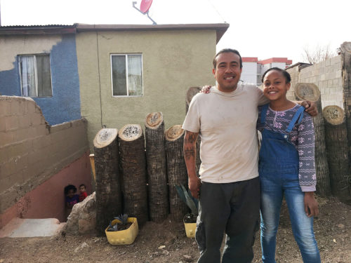 Jesús Alejandro and his stepdaughter, Kimora, pose for a picture at the front of their home in Nogales, Sonora. The family has been living here since three years ago, when Jesús Alejandro was deported from the United States. (Photo by: Genesis Lara/Arizona Sonora News)