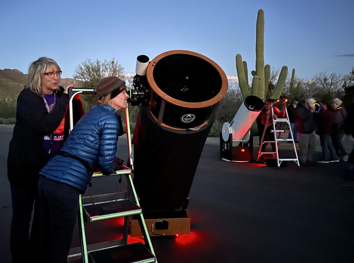 Linda Murphy looks through a telescope at the Stars Over Sabino event at Sabino Canyon in Tucson Ariz. on March 16, 2024. Volunteers from the Mount Lemmon SkyCenter set up telescopes for attendees to view the night sky. (Photograph by Laine Kowalski)