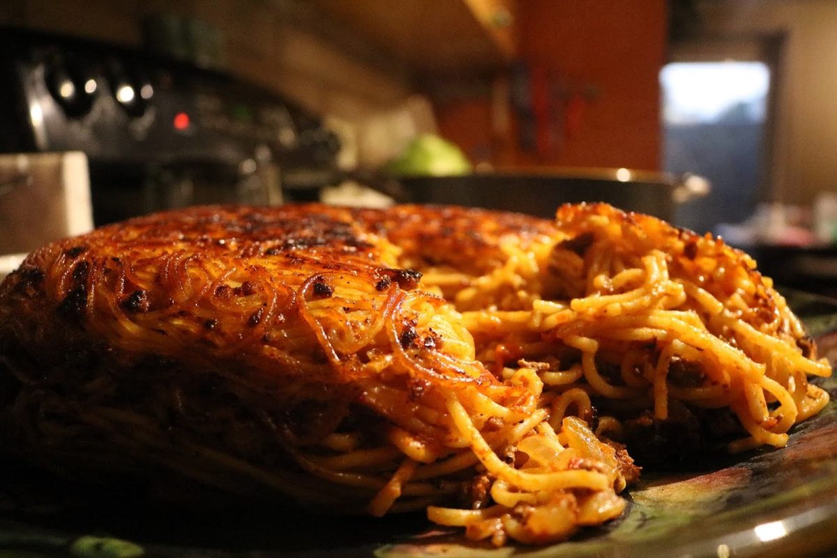 The crispy layer of pasta is broken and ready to be served on Sept. 18. The pot's contents were flipped over onto a large dish to reveal the crispies.