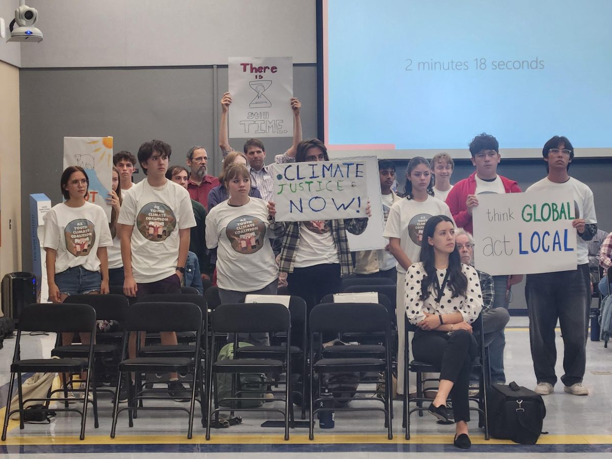 Members held up signs at the October meeting.