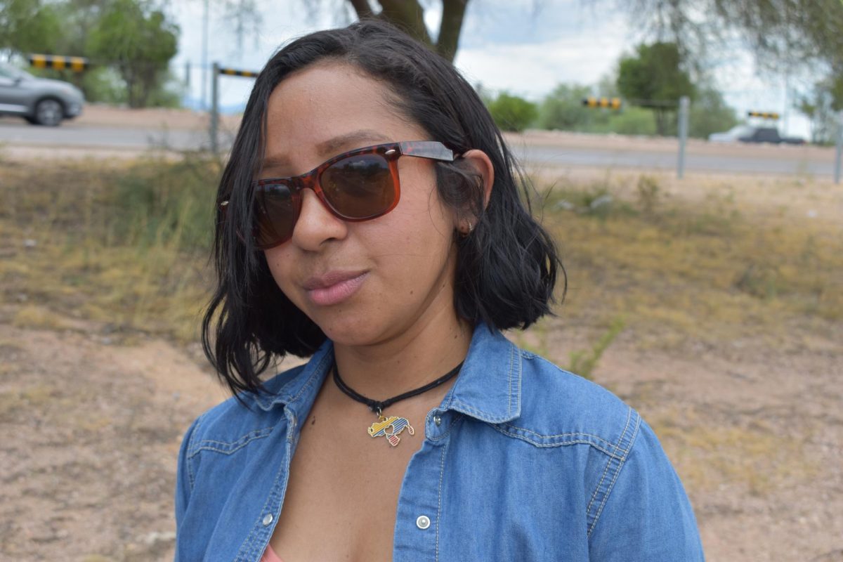 Nagyelyn wears a Venezuela-shaped pendant in the colors of her country’s flag, a symbol of her enduring connection to the homeland she was forced to leave behind.