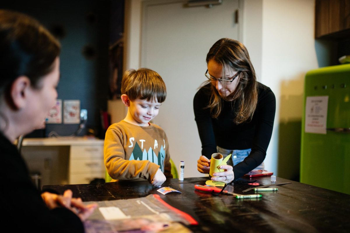 A family makes a craft while visiting the Ronald McDonald Family Room at Diamond Children's Medical Center.