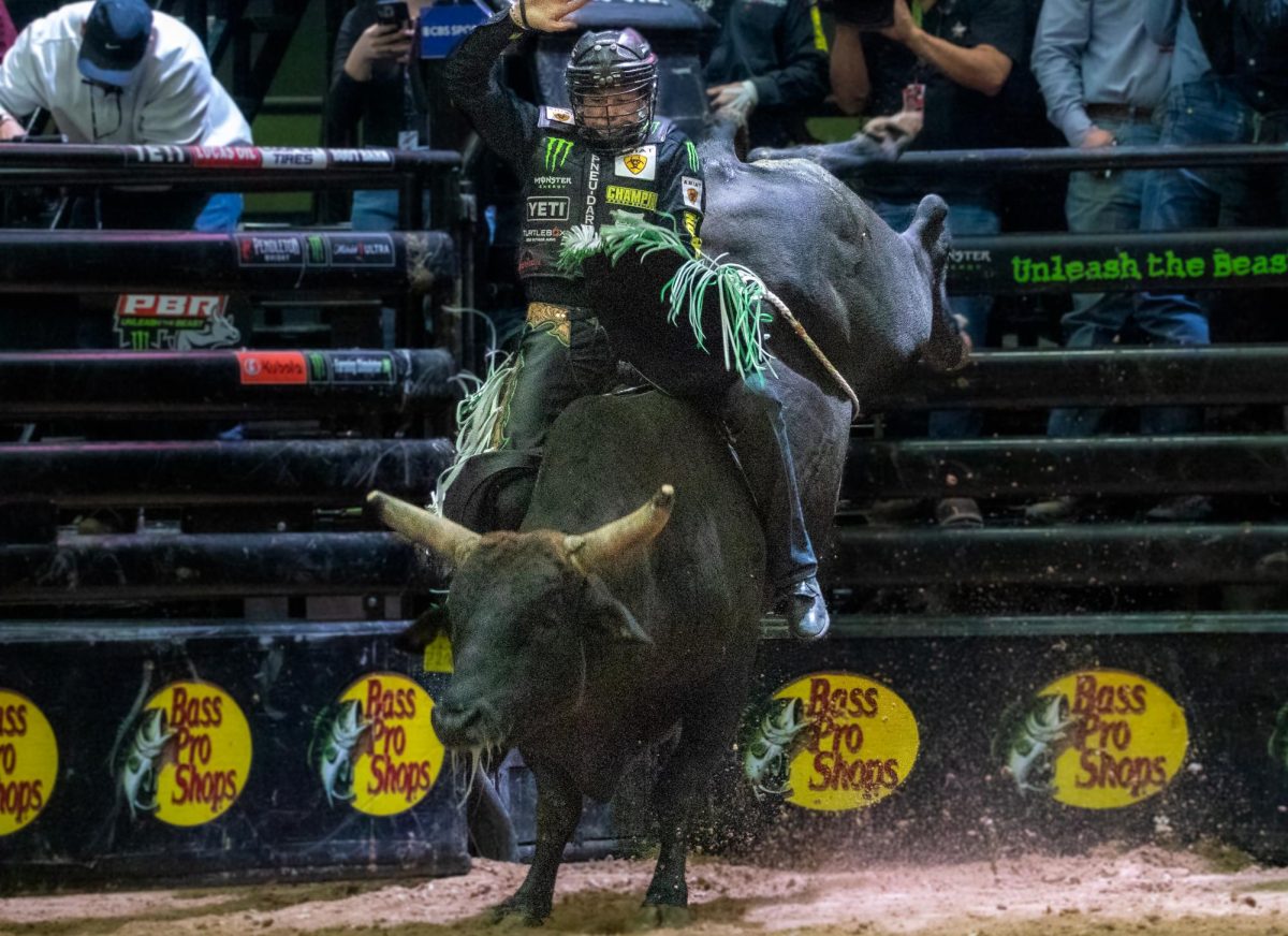 John Cimber a rider in the PBR, rides his final bull of the night staying on for all 8 seconds on Nov. 16 in Tucson Arena. Cimber won the Tucson buckle and over $57,000. 