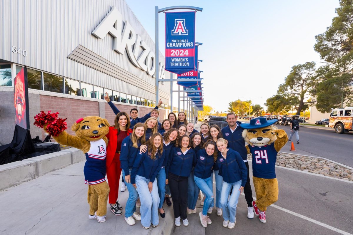 The 2024 Women's Triathlon team poses for a picture under their new banner located on National Championship Drive. (Courtesy of Coach Wes Johnson) 