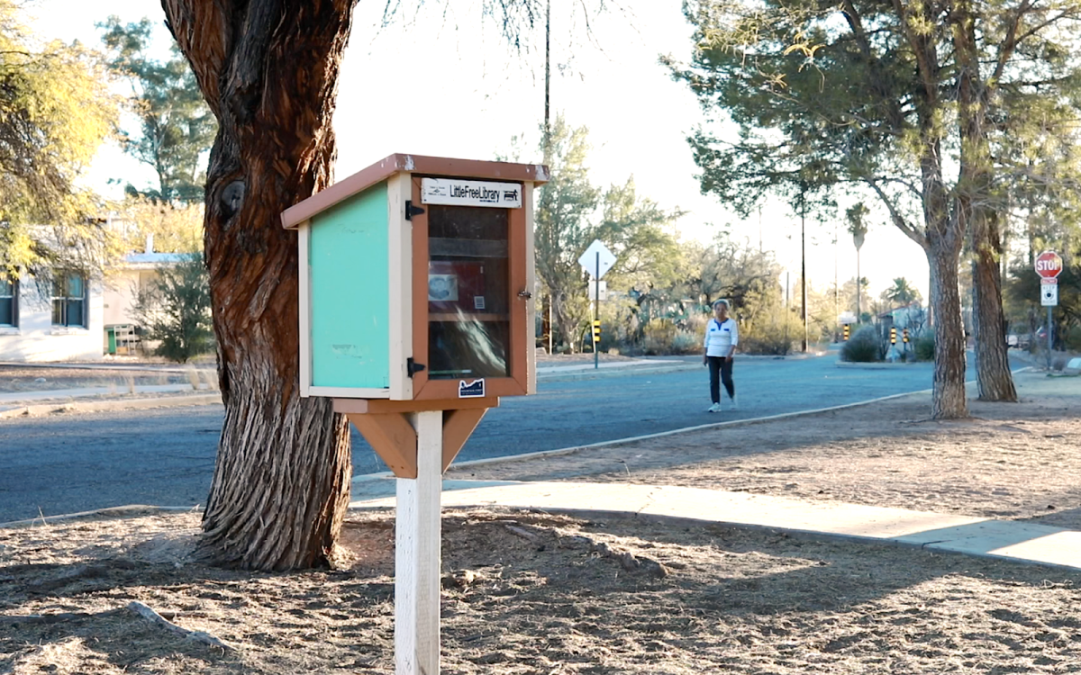 A walker passes the Little Free Library in Mitchell Park on Sunday, Feb. 2, 2025, in Tucson, Ariz.