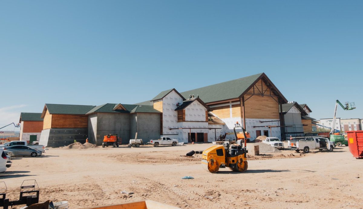 Workers install roofing at the Bass Pro Shops under construction at the Marketplace at the Bridges in south Tucson. The retailer is expected to open in summer 2026.
