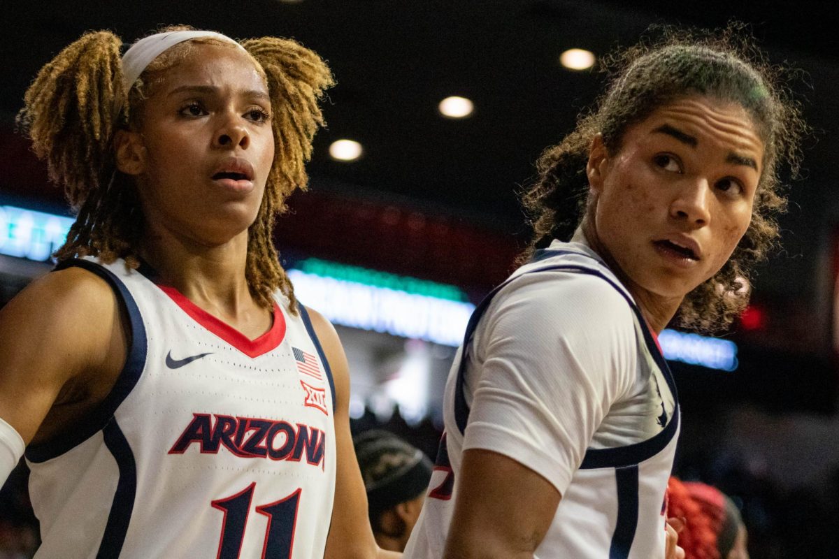 After making a hoop, Noelani Cornfield gets up along with fellow teammate Tanyuel
Welch by her side at McKale Center on Nov. 16.