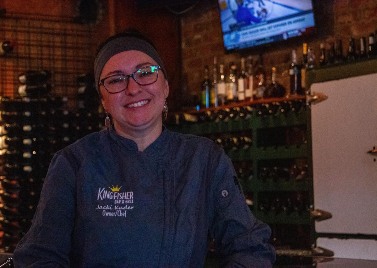 Jacki Kuder, owner and chef of Kingfisher Bar & Grill, poses in front of her bar on Nov. 13, 2025. 