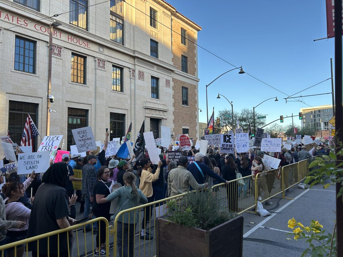 Protesters march through Broadway Boulevard chanting and carrying signs that say “ICE out of our communities” and “We are on stolen land” on Jan. 20, 2025, in Tucson, Arizona. 