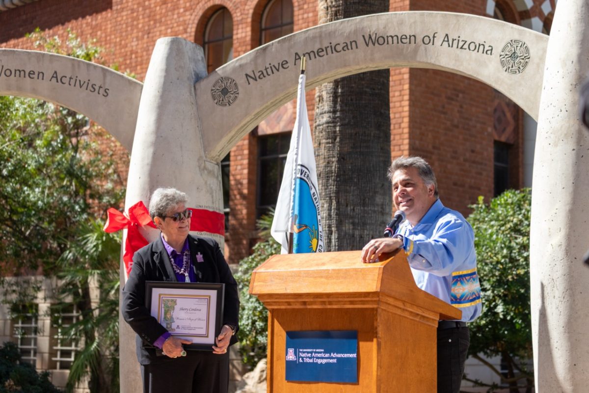 Sherry Cordova. Left, looks on as Levi Esquerra, special adviser to the UA provost for Native American affairs, delivers remarks at Wednesday’s ceremony. (Photo by Kyle Mittan/University Communications)
