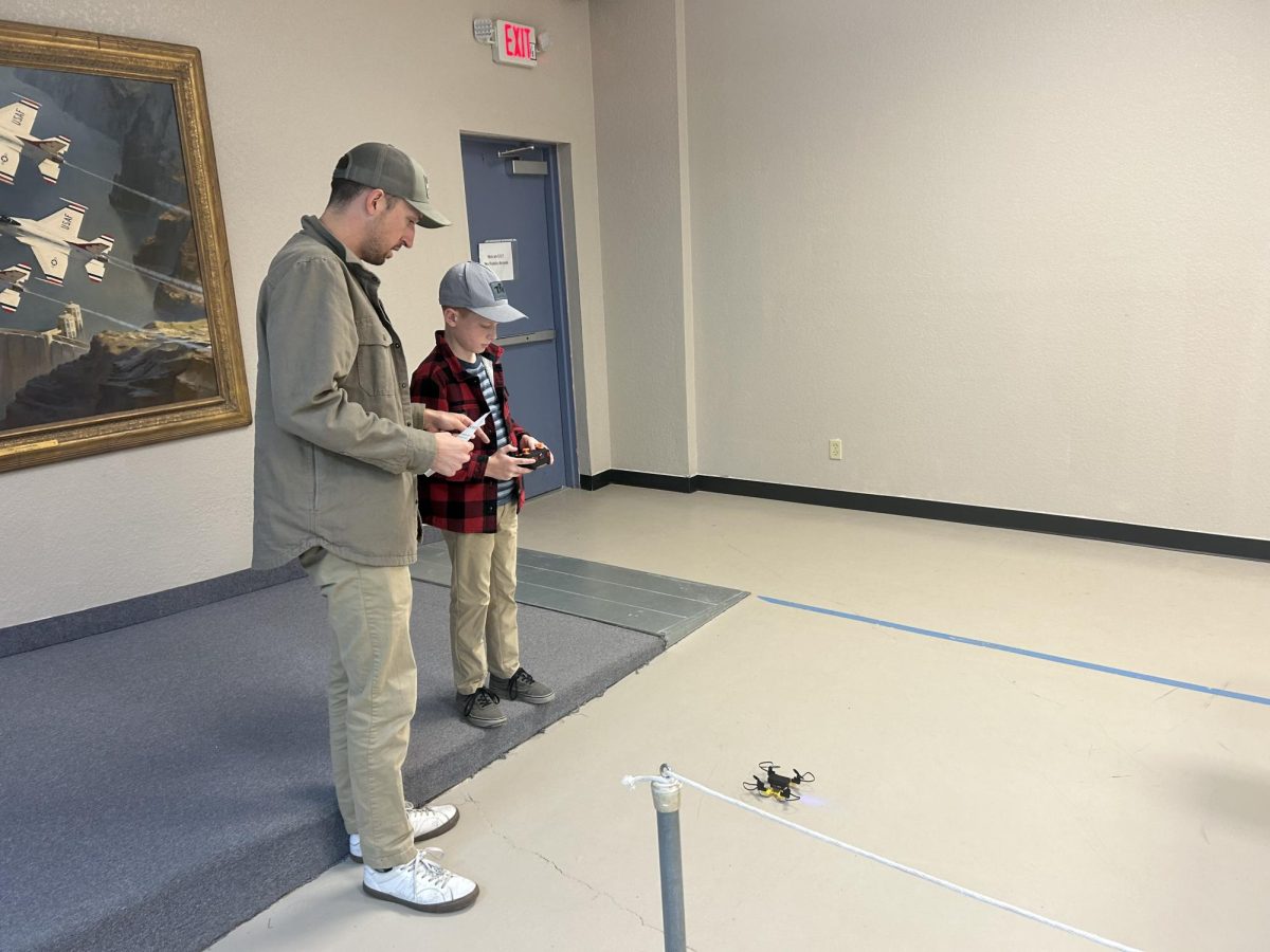A father and son prepare for their drone to take off at the Pima Air & Space Museum in Tucson, Ariz. on Jan. 24, 2026. They are the first flyers of the Fly-A-Drone Day and navigate a miniature obstacle course. 