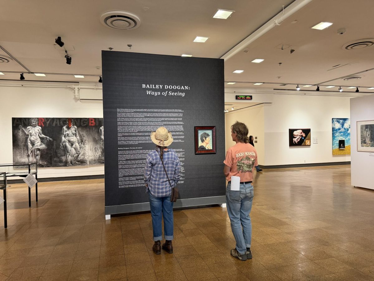 Guests read the introduction to the exhibition “Ways of Seeing” at the University of Arizona Museum of Art on March 4, 2026. 
