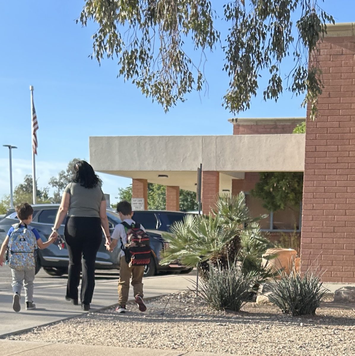 A mother walks her children into Amphitheater’s Nash Elementary School. The school at 515 West Kelso St. in Tucson is one of four in the district slated to close after this school year. 
